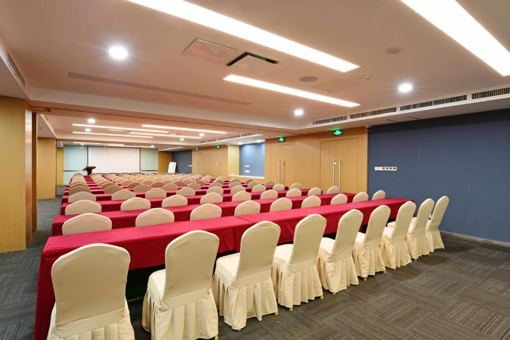 a conference room with rows of chairs and a podium at Holiday Inn Express Changchun High-Tech Zone by IHG in Changchun