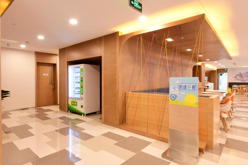 a lobby of a restaurant with a sign on the wall at Holiday Inn Express Changchun High-Tech Zone by IHG in Changchun
