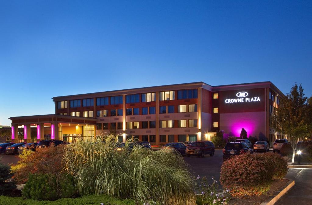 un edificio con coches estacionados en un estacionamiento en Crowne Plaza Boston - Woburn, an IHG Hotel en Woburn