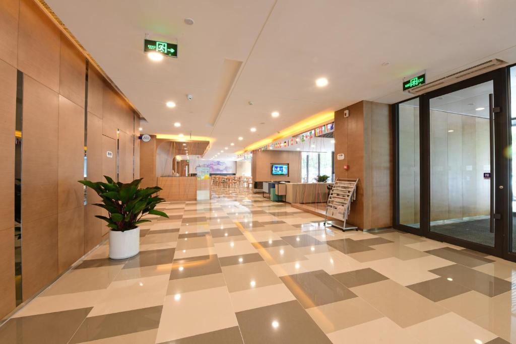 a hallway with a potted plant in a building at Holiday Inn Express Changchun High-Tech Zone by IHG in Changchun