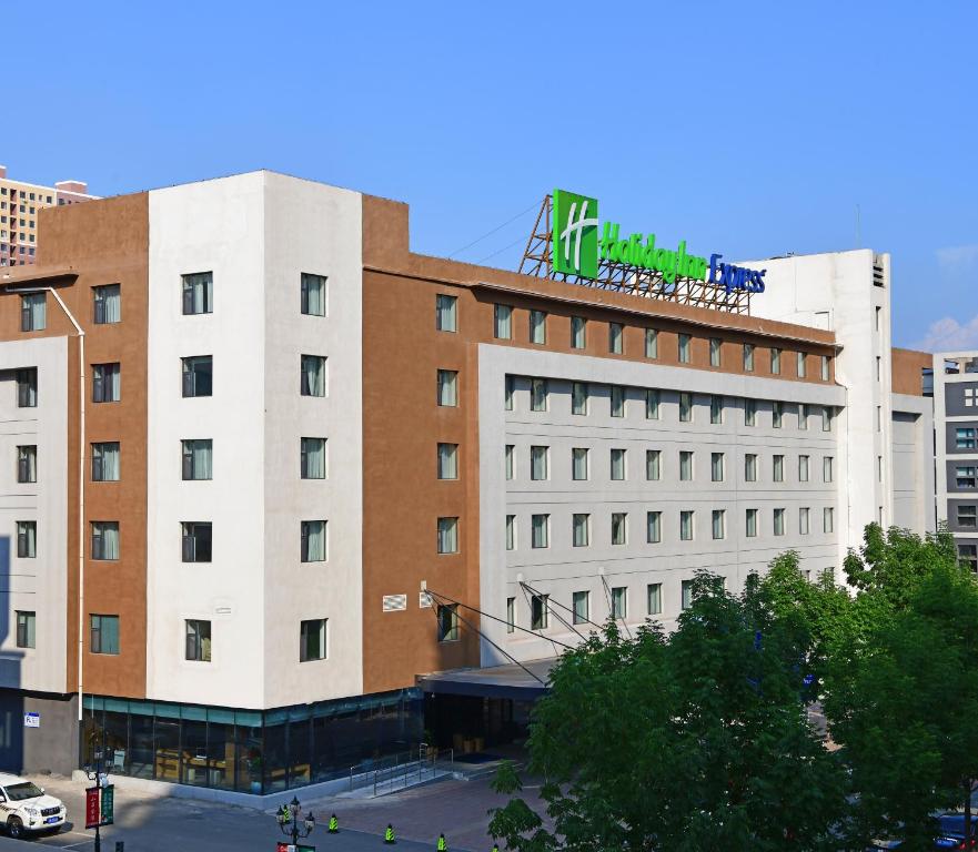 a hotel building with a sign on top of it at Holiday Inn Express Changchun High-Tech Zone by IHG in Changchun