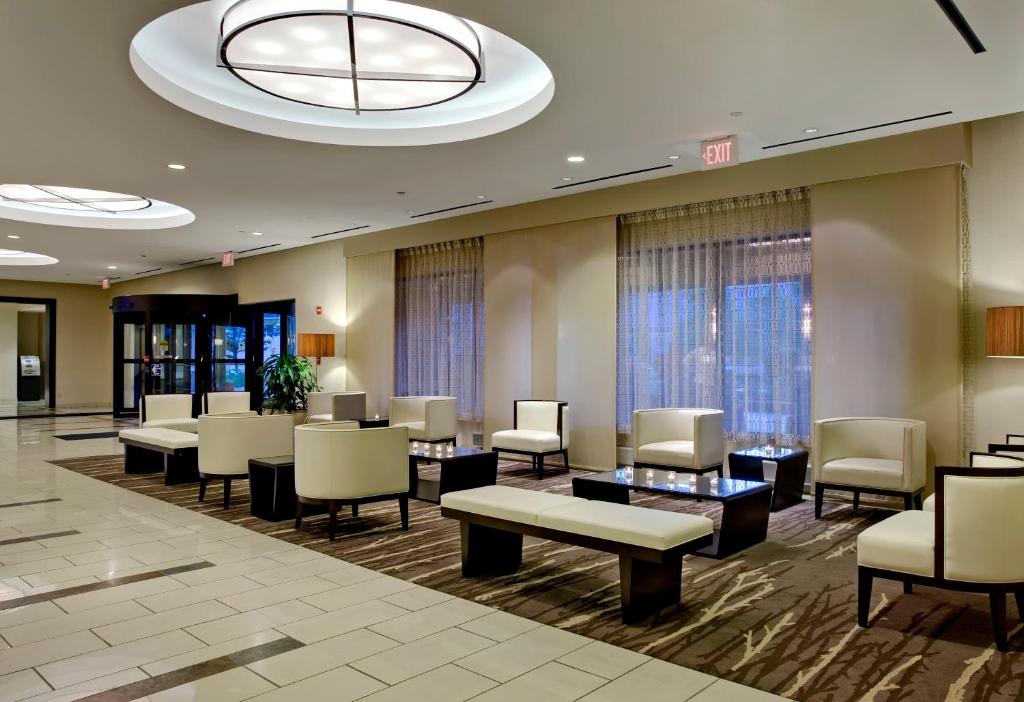 a waiting room at a hospital with chairs and tables at Crowne Plaza Chicago O'Hare Hotel & Conference Center by IHG in Rosemont