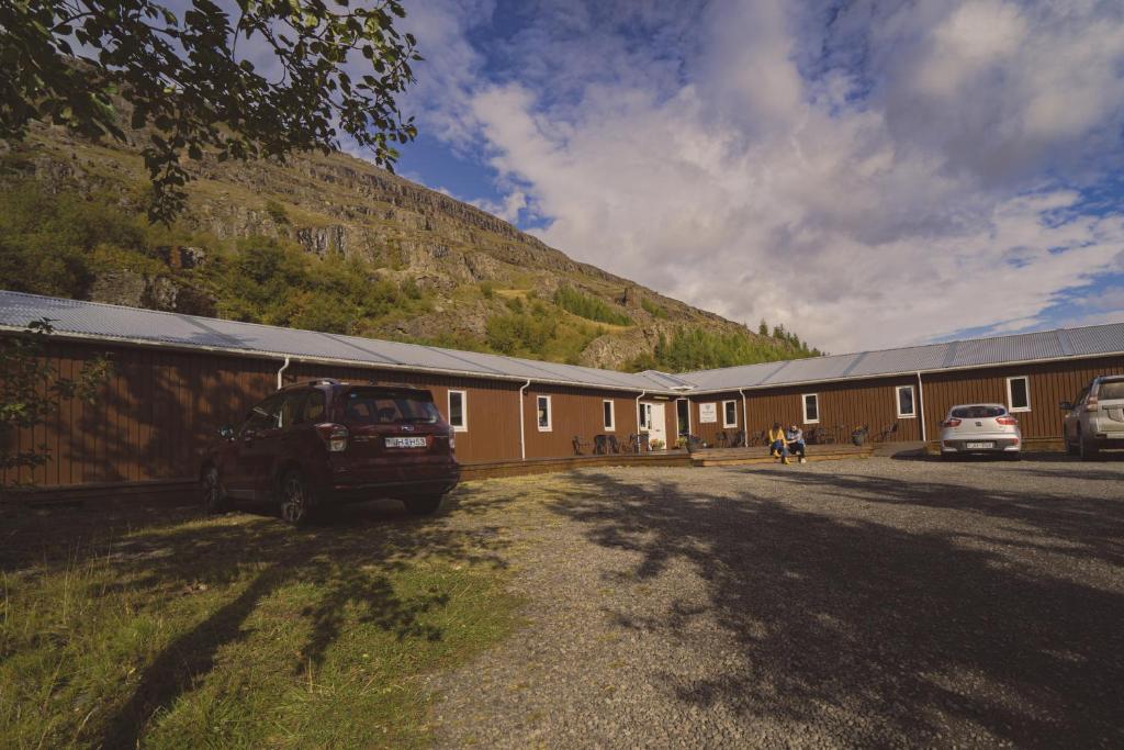 a car parked in a parking lot next to a building at Hengifoss Guesthouse in Valþjófsstaður