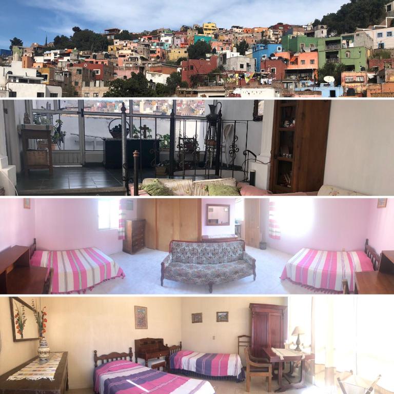 a room with a bed and a view of a city at Casona del Ropero in Guanajuato