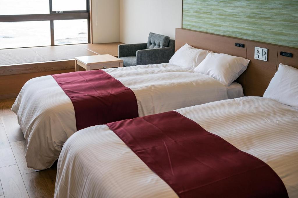 Postel nebo postele na pokoji v ubytování Oarai Hotel Annex Gyoraian