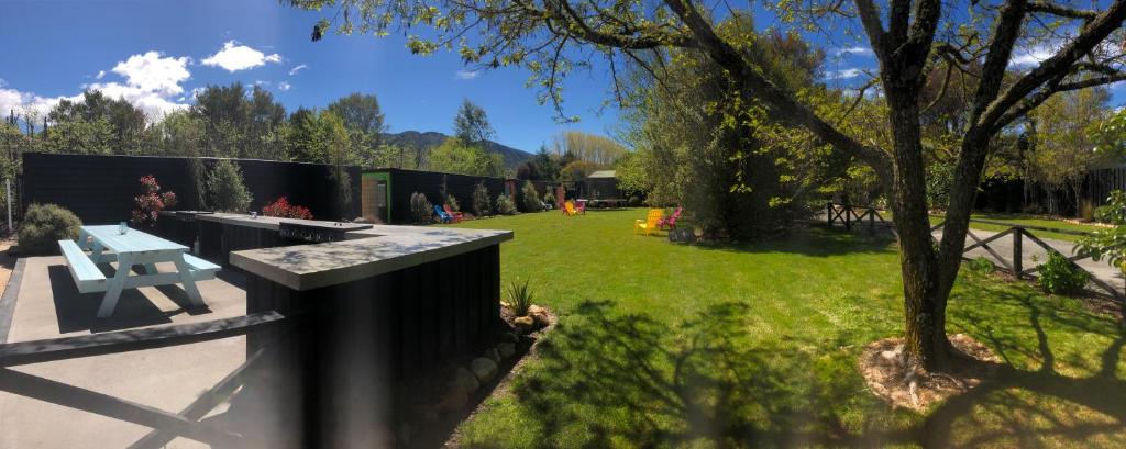 a park with a bench and a fence at Adventure Inn Marahau in Marahau