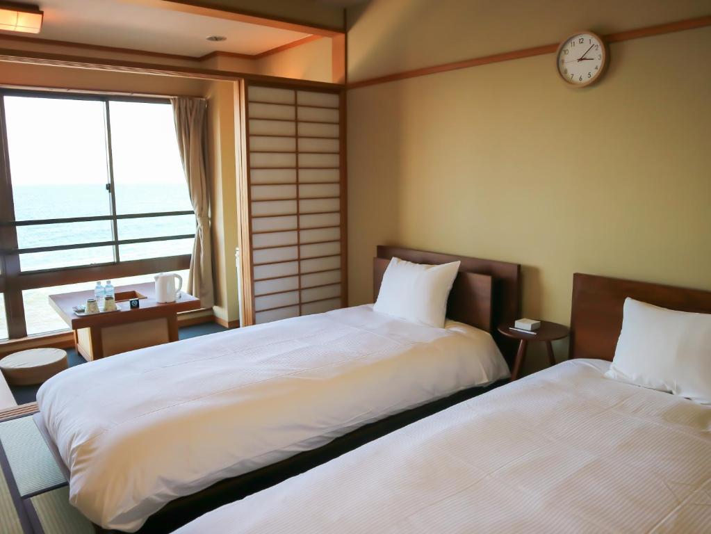 Postel nebo postele na pokoji v ubytování HOTEL&RESORT Izu no Ne