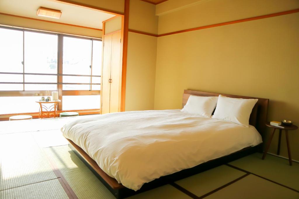 Postel nebo postele na pokoji v ubytování HOTEL&RESORT Izu no Ne
