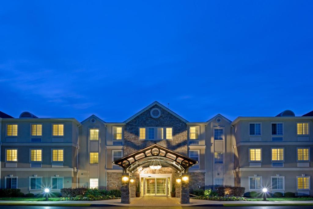 a large apartment building with an entrance at night at Staybridge Suites-Philadelphia/Mount Laurel, an IHG Hotel in Mount Laurel