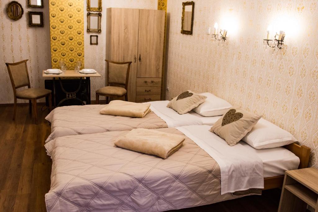 two beds with pillows on them in a room at Boki Apartmant in Subotica