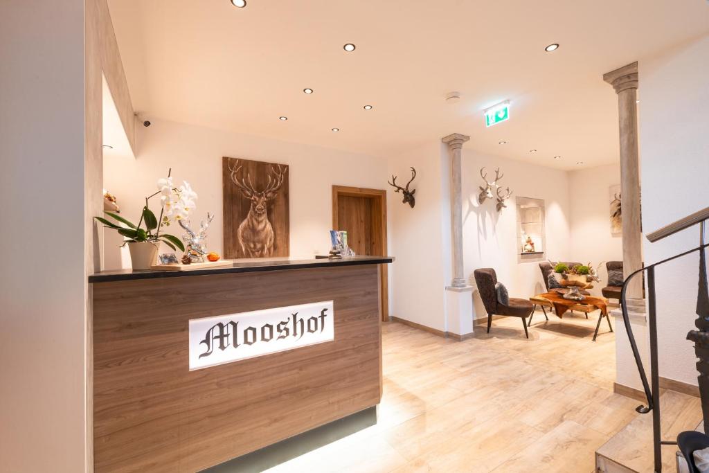 a salon with a reception desk in a room at Apartments Mooshof in Neustift im Stubaital