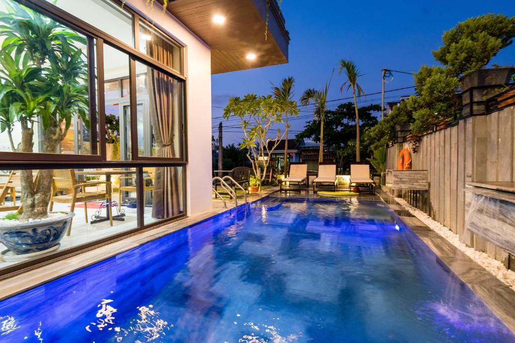 a swimming pool in the backyard of a house at Ancient River Villa in Hoi An