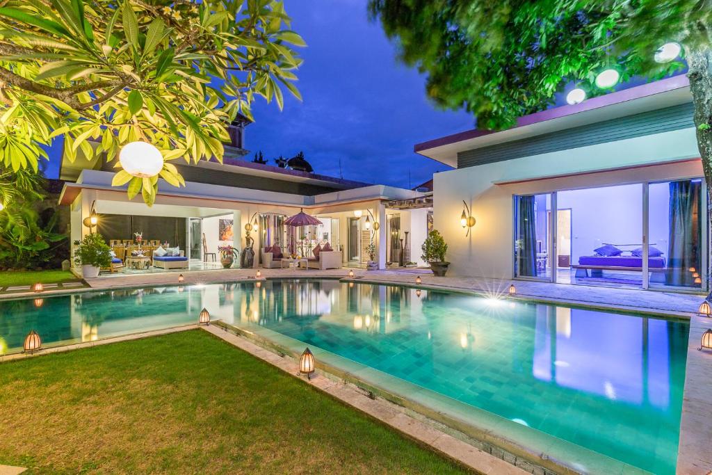 an image of a house with a swimming pool at Villa Purple in Legian