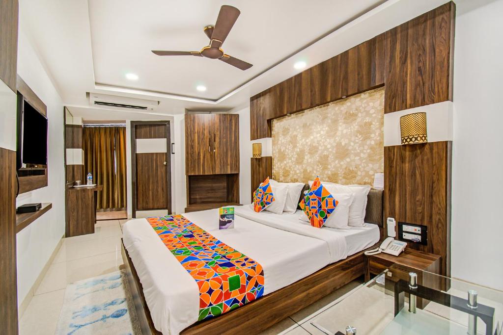 a bedroom with a large bed in a room at FabHotel Rajnandani Residency Bhawarkua in Indore