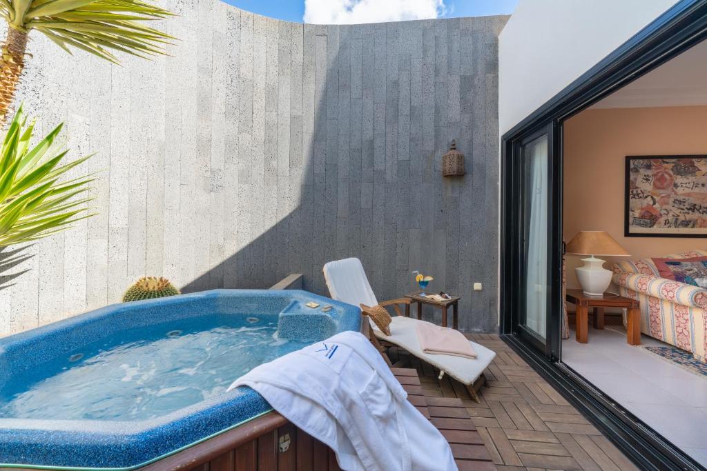 a jacuzzi tub on the balcony of a house at Villa VIK - Hotel Boutique in Arrecife