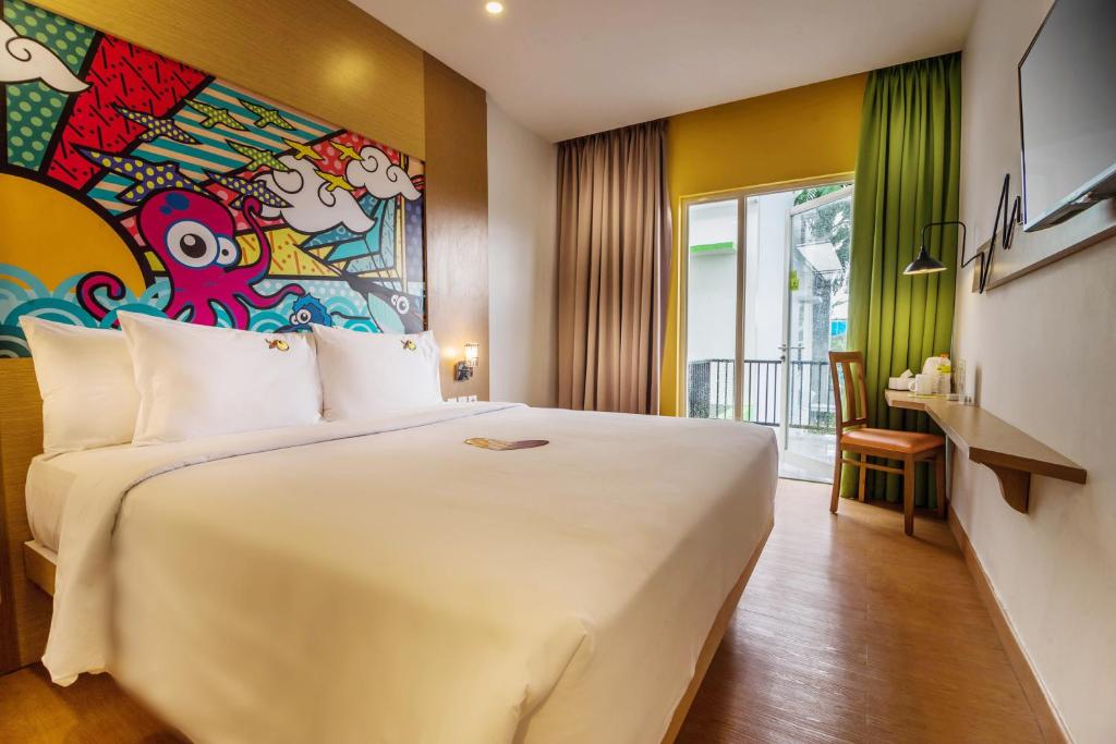 Postel nebo postele na pokoji v ubytování MaxOneHotels at Resort Makassar