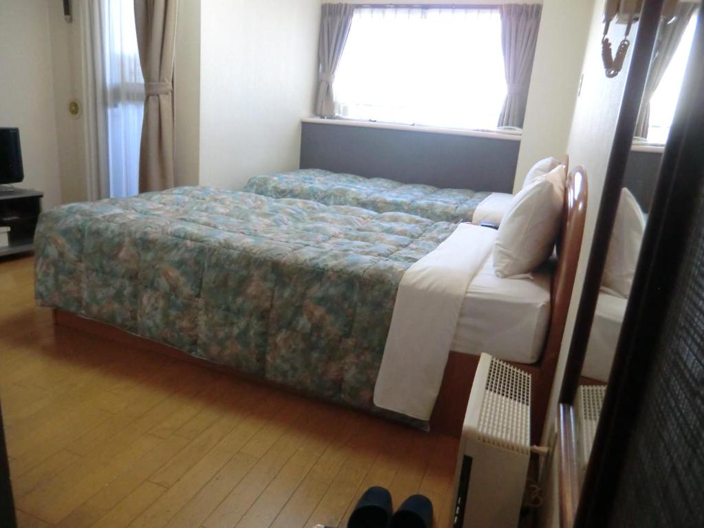 Postel nebo postele na pokoji v ubytování Azu Garden Nippombashi