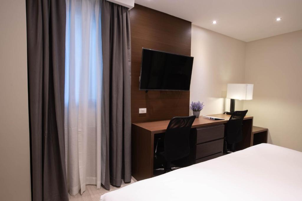 Postel nebo postele na pokoji v ubytování Coro Hotel