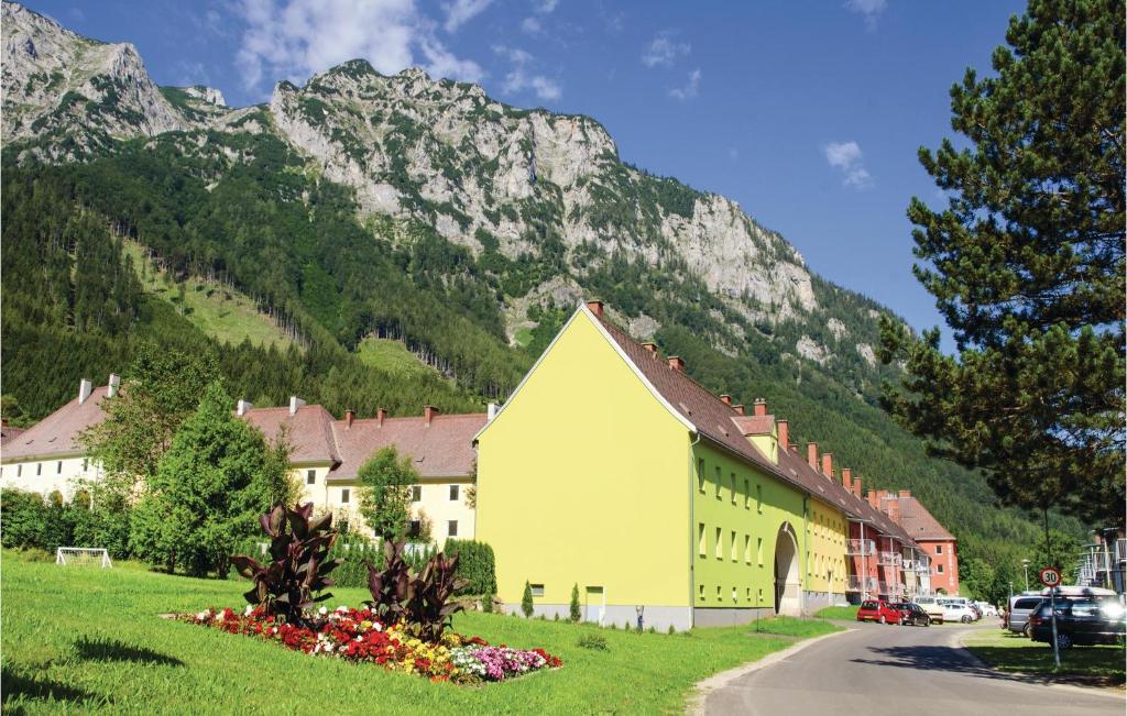 a yellow building in front of a mountain at Stunning Apartment In Eisenerz With 2 Bedrooms And Wifi in Eisenerz