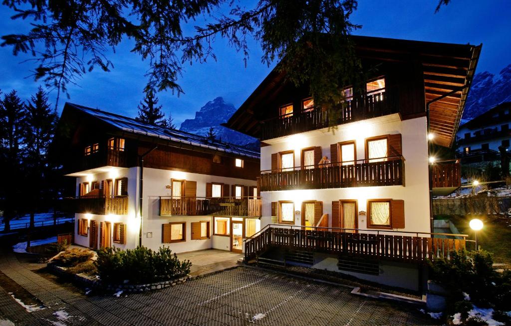 a large building with lights in front of it at Residence Peniè in San Vito di Cadore