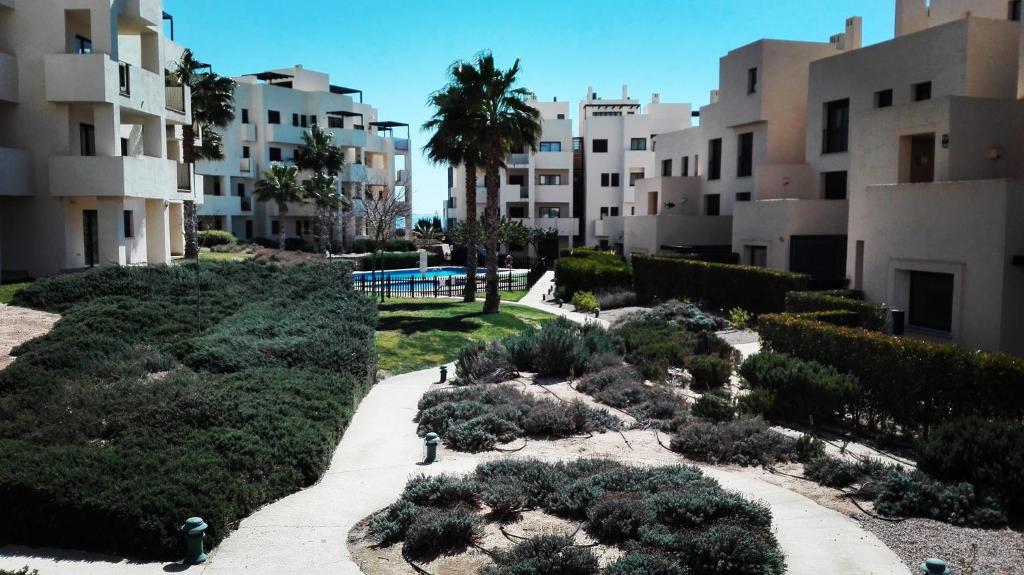 a garden in front of some apartment buildings at gelijkvloers appartement Corvera Golf & Country Club in Corvera