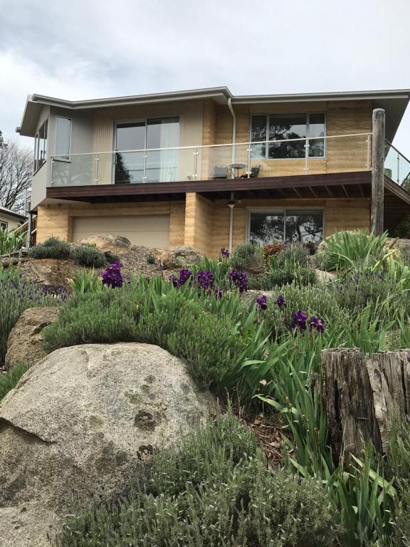 a house on top of a hill with flowers at SIGNAL BOX Short Stay in Gembrook