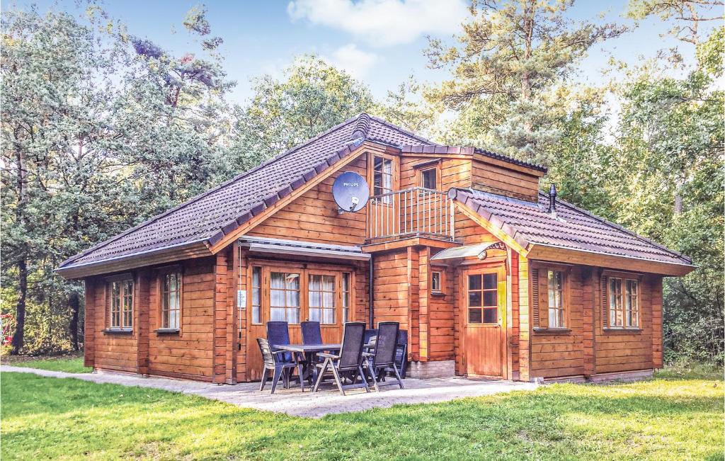 a log cabin with a table and chairs in front of it at 5 Bedroom Gorgeous Home In Neede in Gelselaar