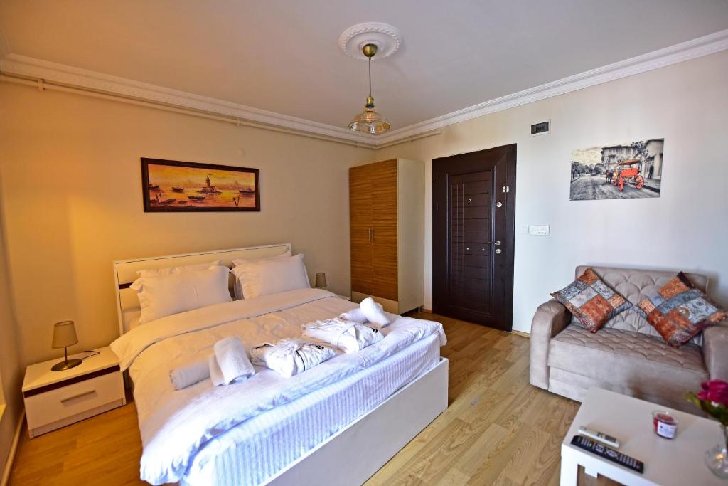 a bedroom with a large bed and a couch at Sunshine Taksim Suite in Istanbul