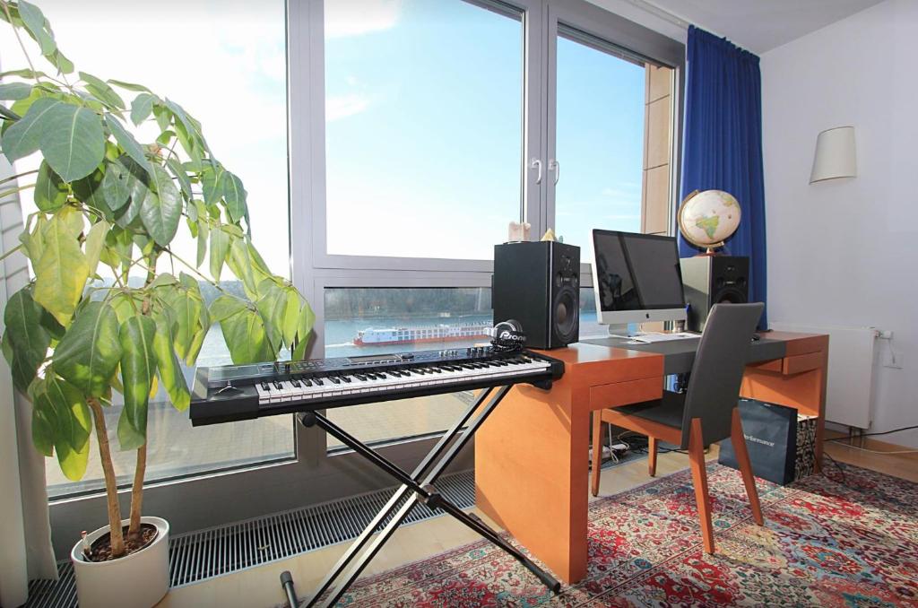 an office with a keyboard and a desk with a computer at Luxury space at the best address in Bratislava in Bratislava