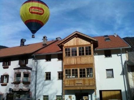 a hot air balloon flying over a building at Appartamenti Milli in San Candido