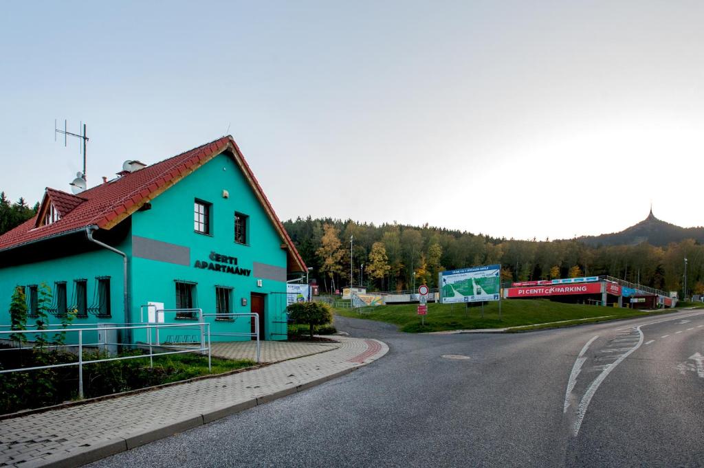 niebieski budynek przy drodze w obiekcie Čerti Apartmány w mieście Liberec