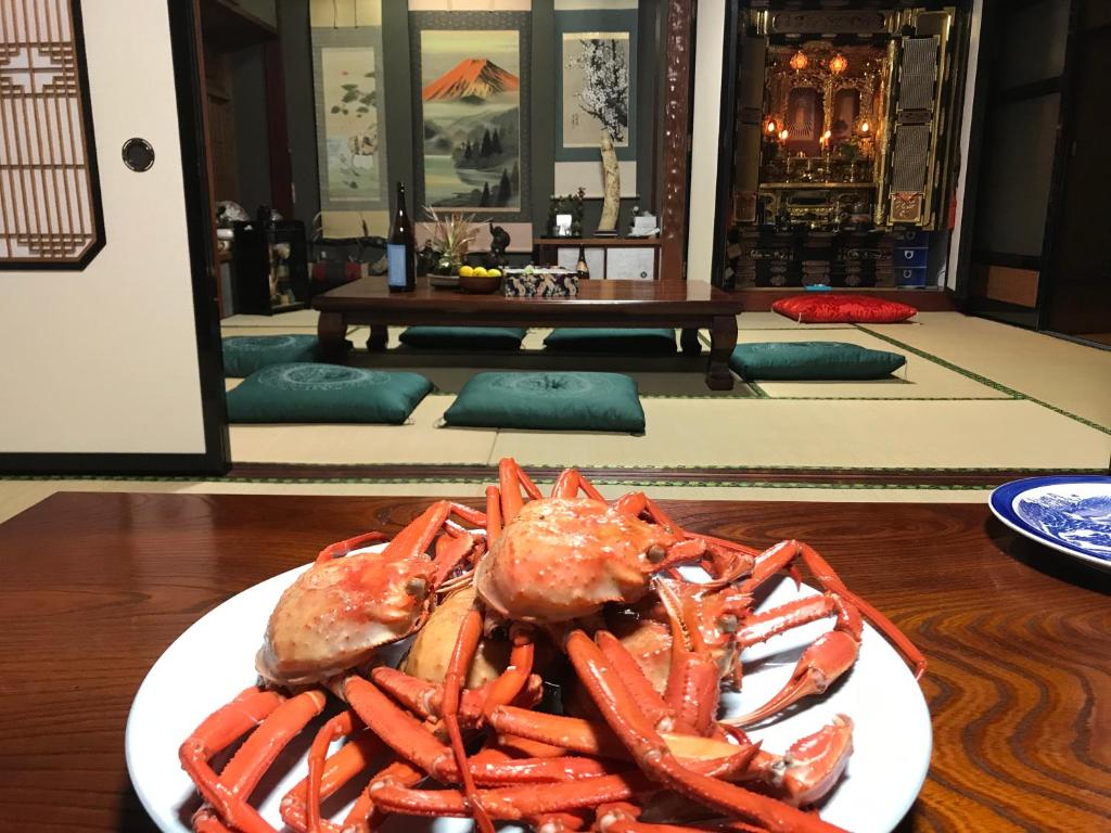 un plato de langostas sentado en una mesa de madera en Relaxing house de Akemi, en Shimminato