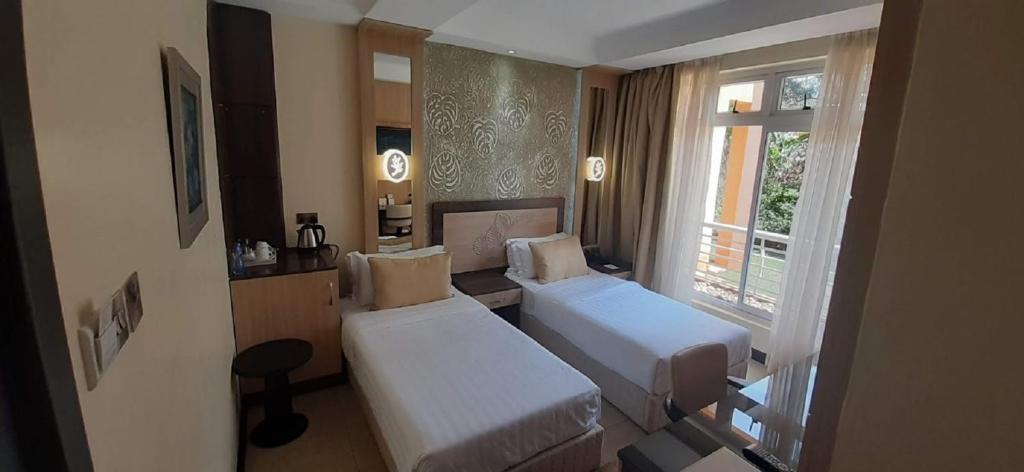 Postel nebo postele na pokoji v ubytování Elysian Resort