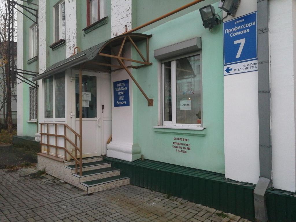 ein Gebäude mit einer Tür mit einem Schild darauf in der Unterkunft Vash Dom Hotel Somova in Murmansk