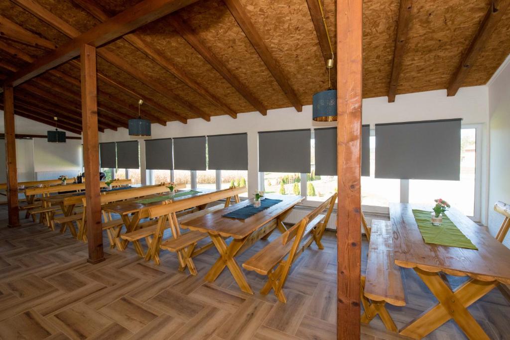 a large dining room with wooden tables and chairs at OPG HORVAT SOBE ZA ODMOR in Daruvar