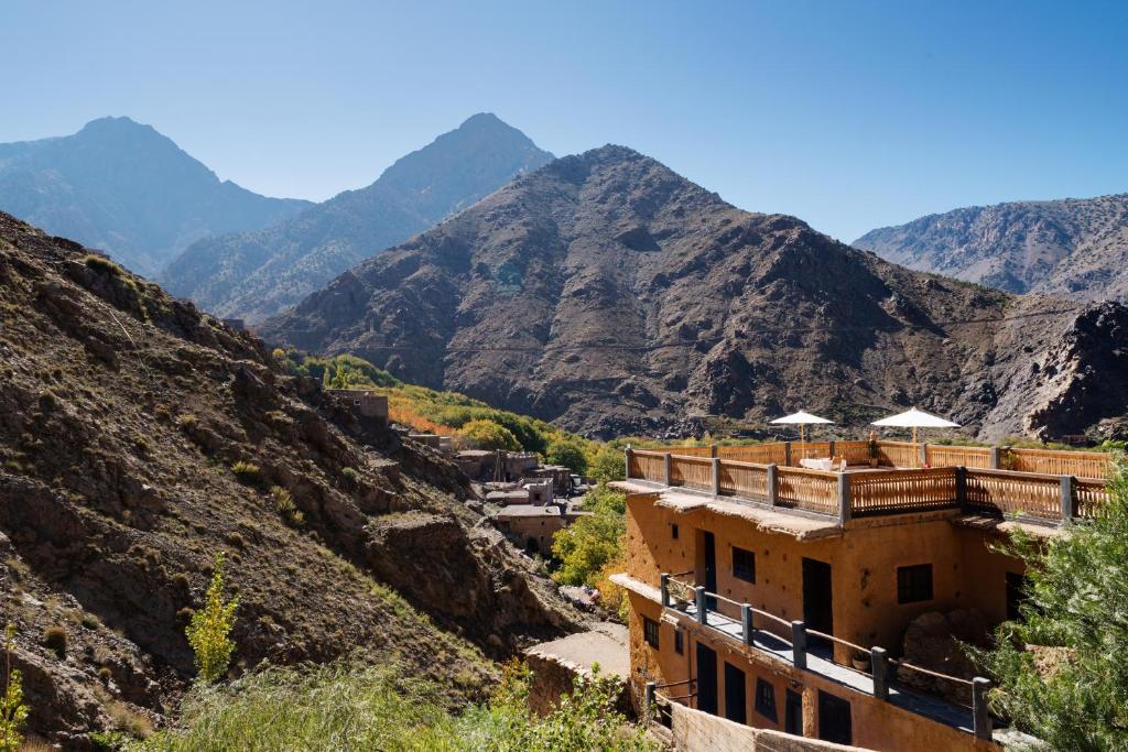 a building in a canyon with mountains in the background at Le Village du Toubkal in Imlil