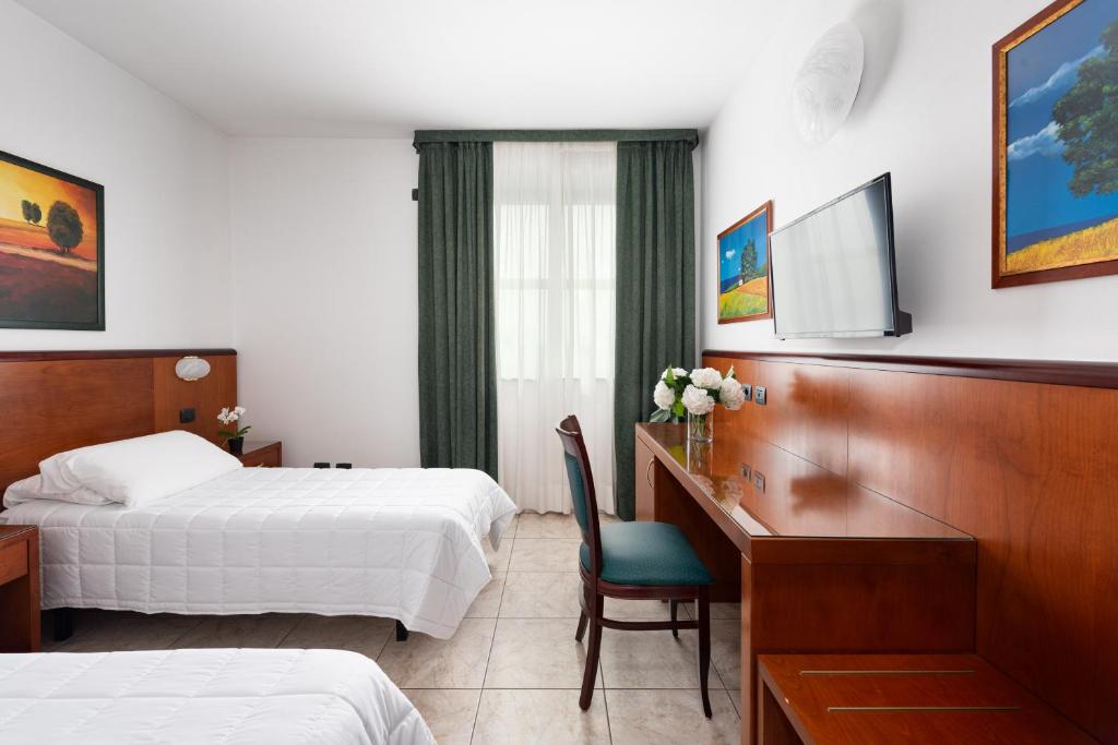Postel nebo postele na pokoji v ubytování Rivoli Hotel