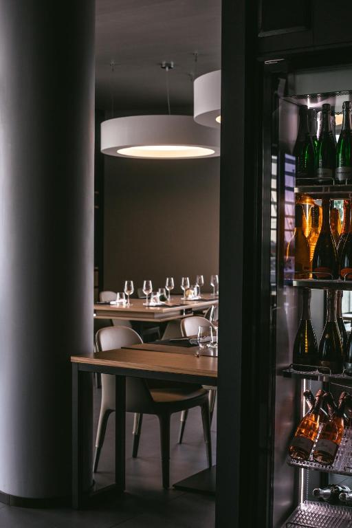 a dining room with tables and wine glasses at Mosella Suite Hotel in Sottomarina