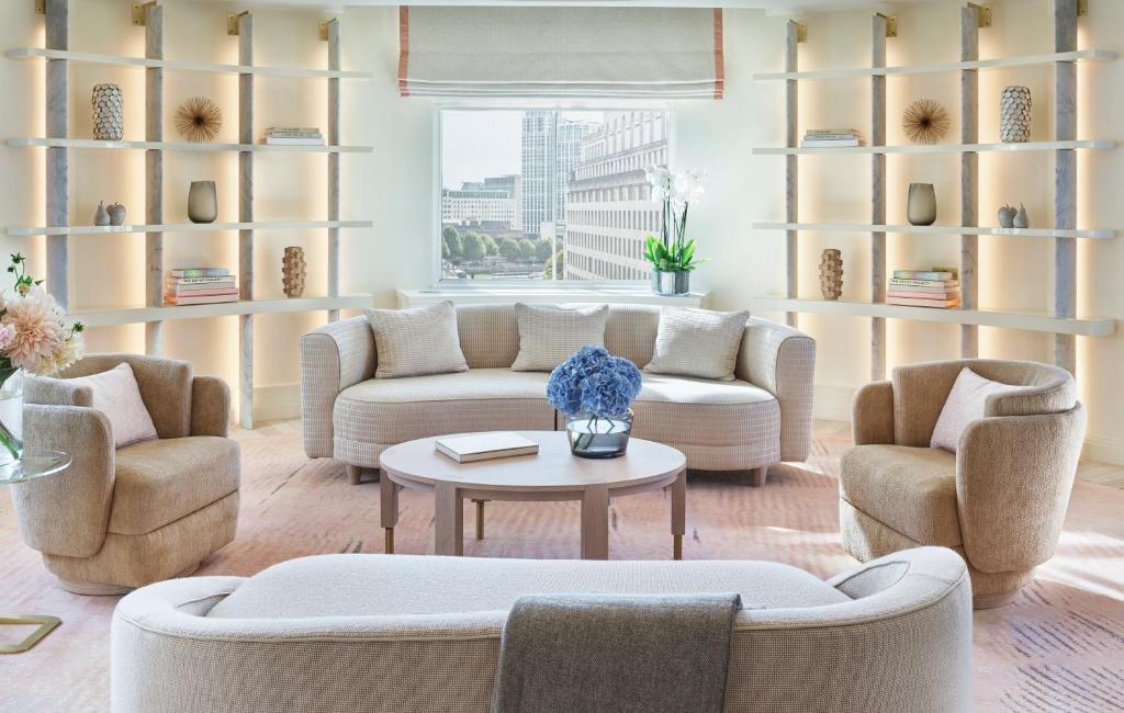 a living room with a couch and two chairs and a table at One Aldwych in London