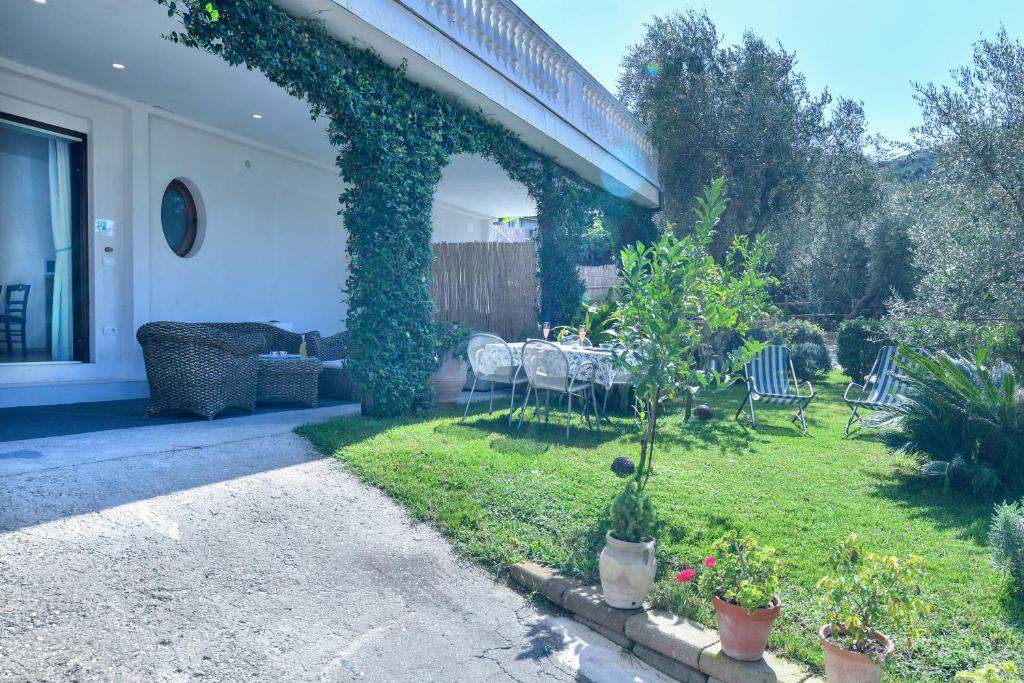 a patio with a table and chairs in a yard at Il Profumo di Capri in Massa Lubrense