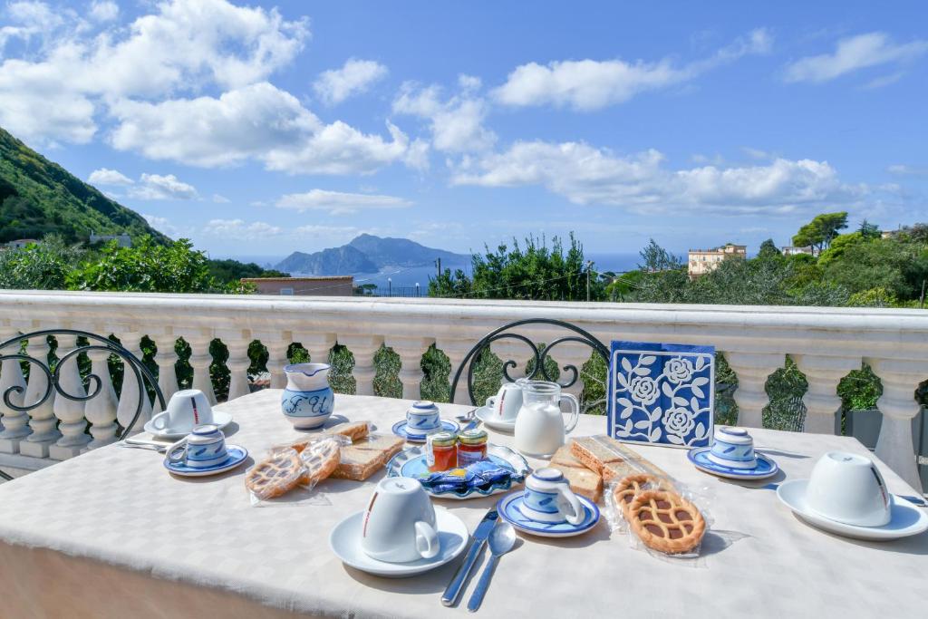 a table with food on top of a balcony at Il Profumo di Capri in Massa Lubrense
