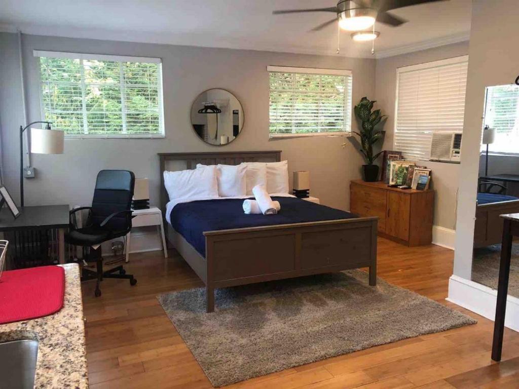 a bedroom with a bed and a desk and a chair at Chic ATL Studio - 5 mins walk Emory CDC in Atlanta