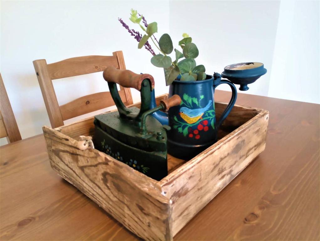 una caja de madera con tetera y un hervidor de agua sobre una mesa en Acogedor apartamento VALLE DEL JERTE, en Piornal