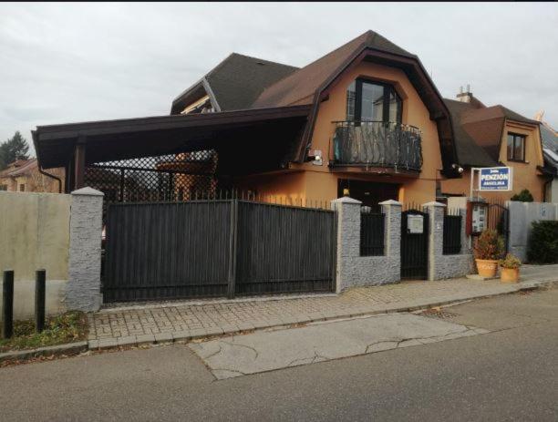 a house with a fence in front of it at Penzion Angelika in Bratislava