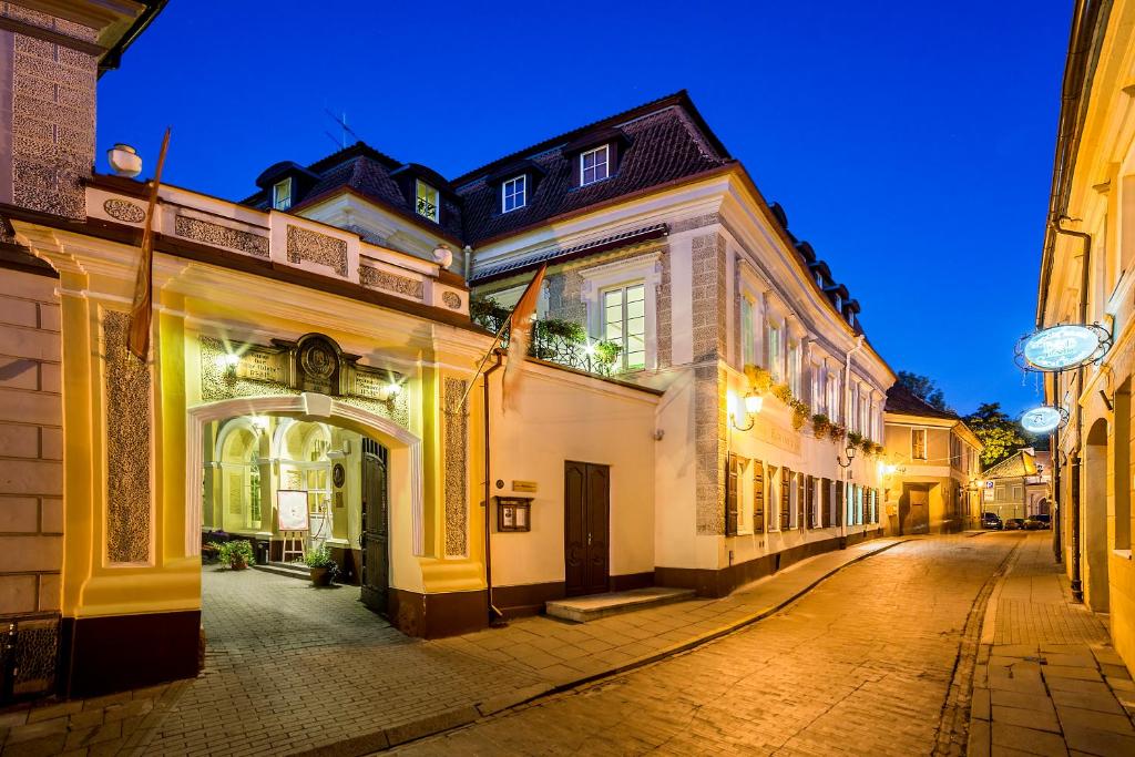 an empty street in an old town at night at Shakespeare Boutique Hotel in Vilnius