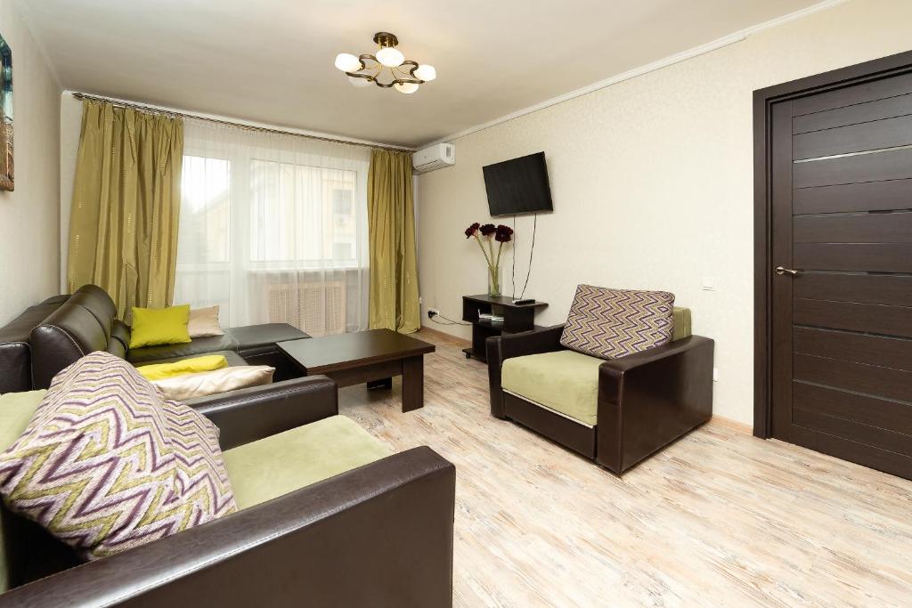 a living room with a couch and a chair at Apartment in the city center in Baranavichy