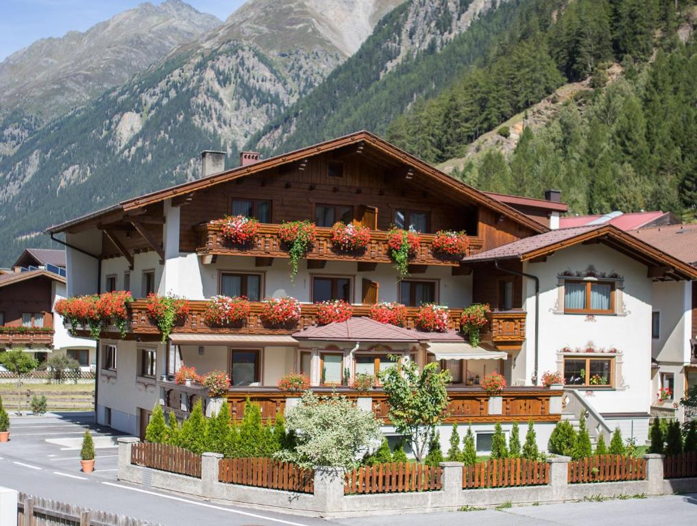 a building with flower boxes on the side of it at Gästehaus Falkner Ignaz in Sölden
