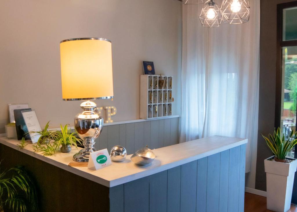 a table with a lamp on top of it at Hotel Positano in Bassano del Grappa