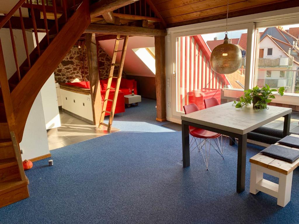 a dining room with a table and a staircase at Historische Ferienwohnung mit Sauna in Lich in Lich