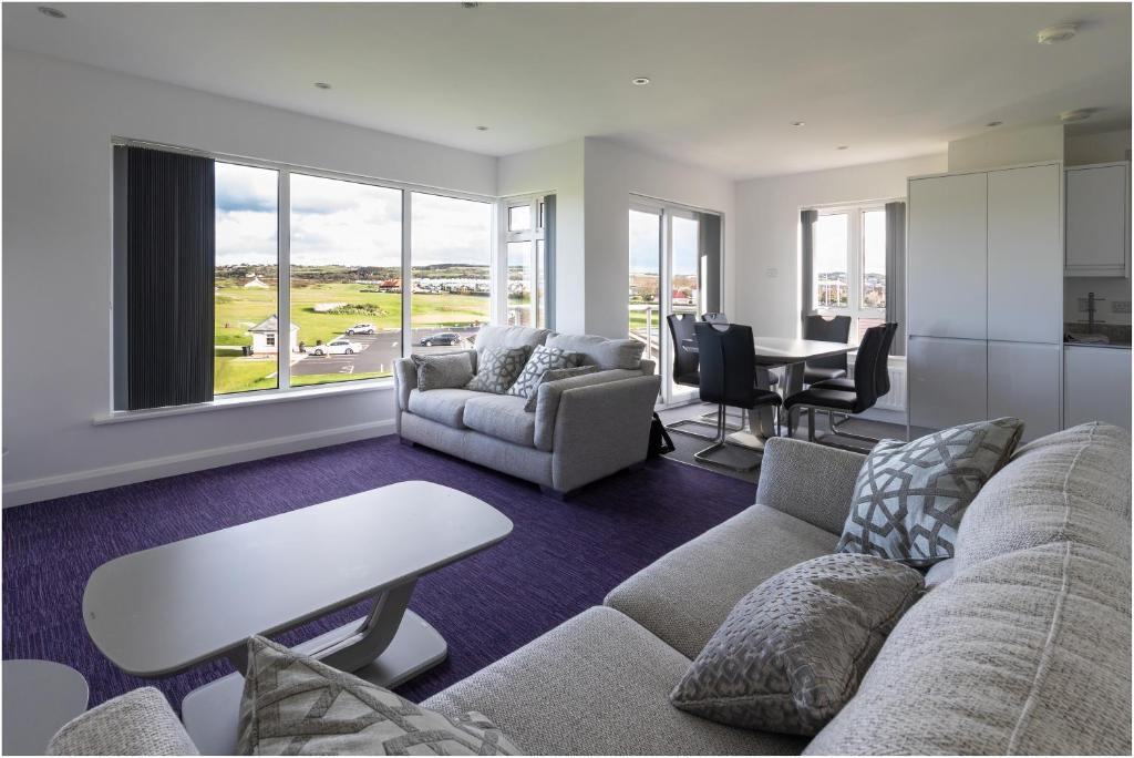 a living room with a couch and a table at 3, The Links in Portrush